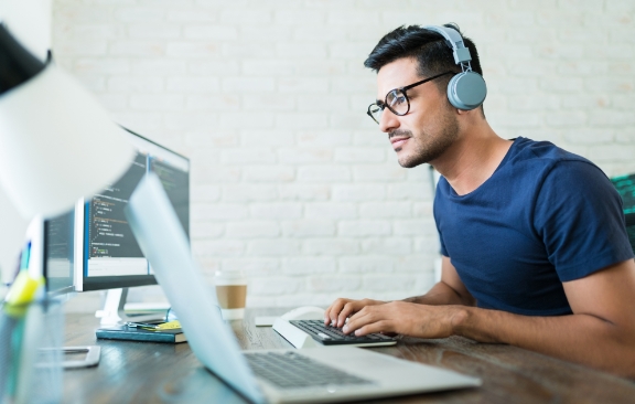 A developer working at his computer desk.